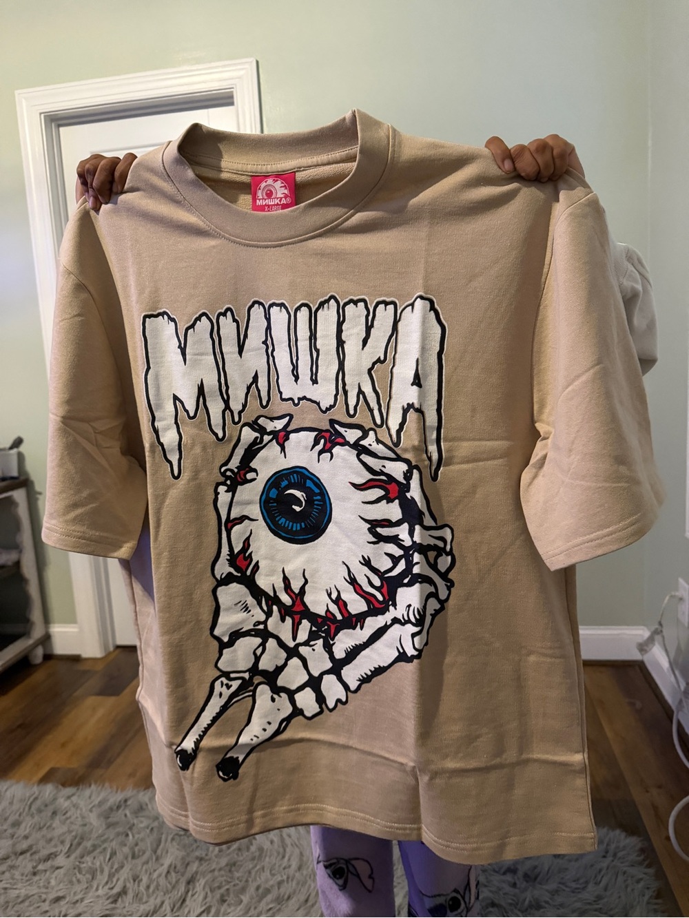 Mishka Tan Graphic Tee with Blue Eyeball Print